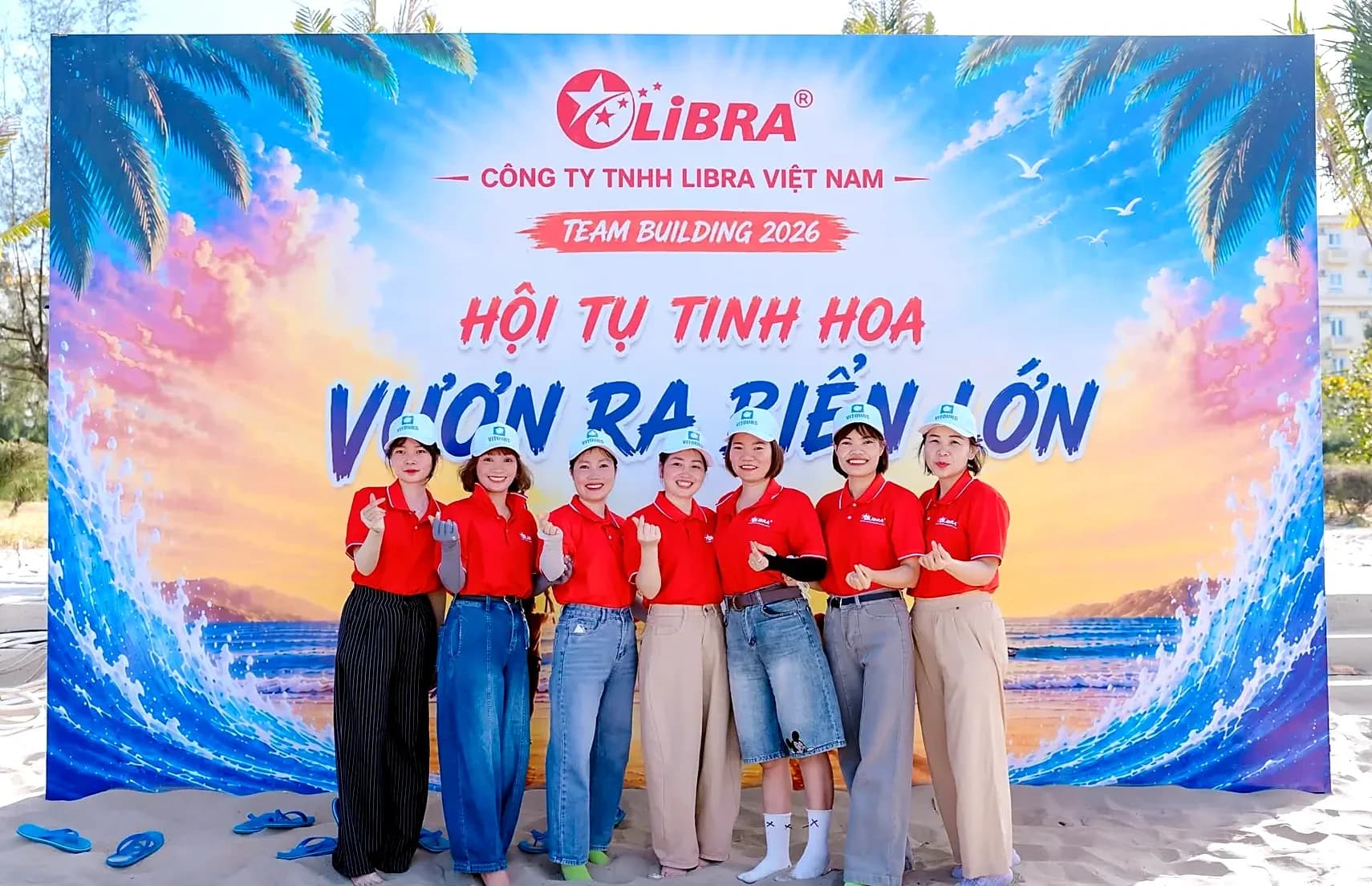 Colleagues in front of the Team building 2026 backdrop