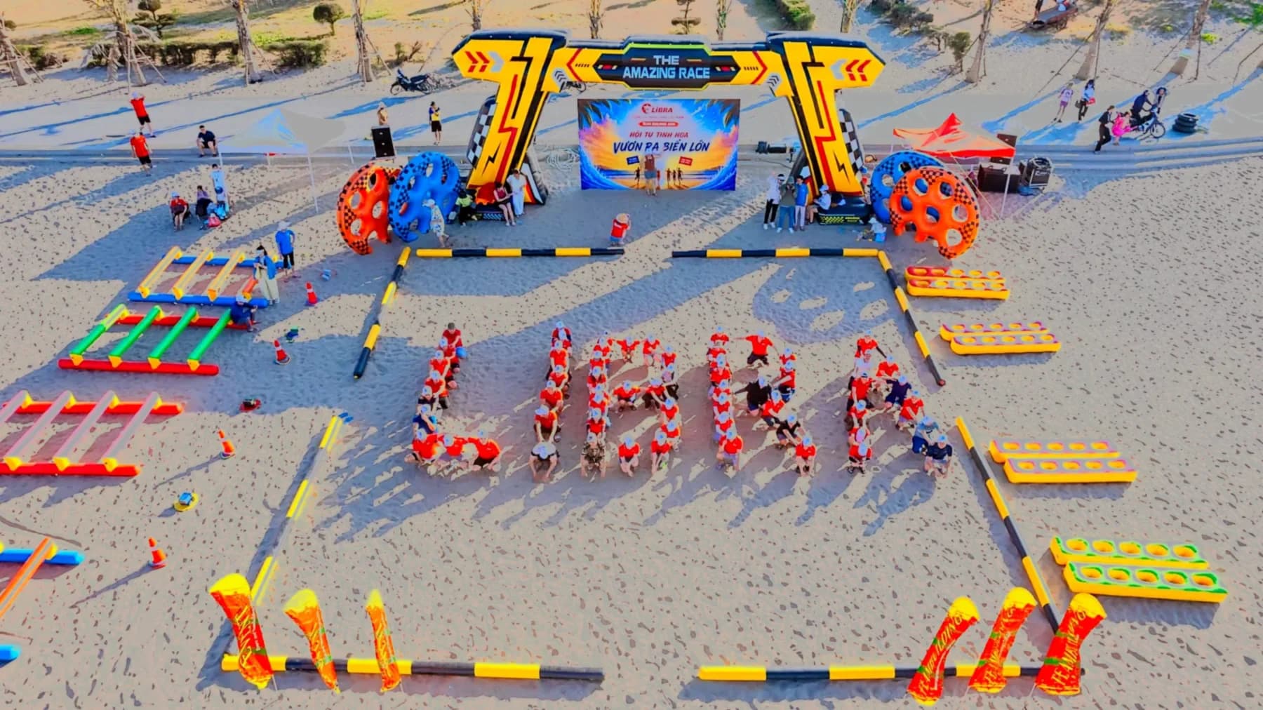 Aerial view of the team forming the word LIBRA