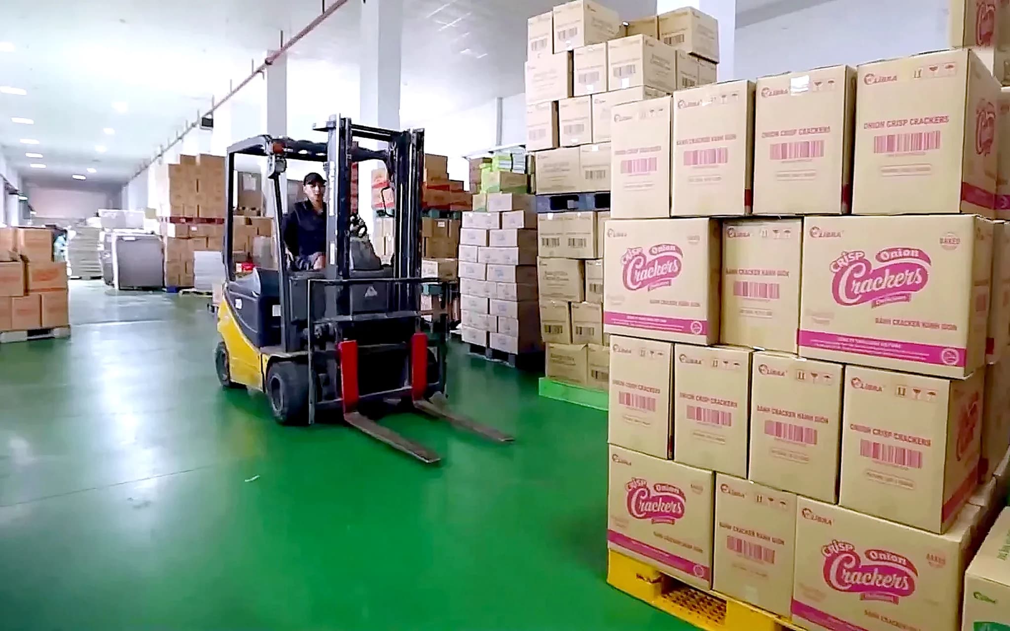 Forklift moving cartons in the finished-goods warehouse