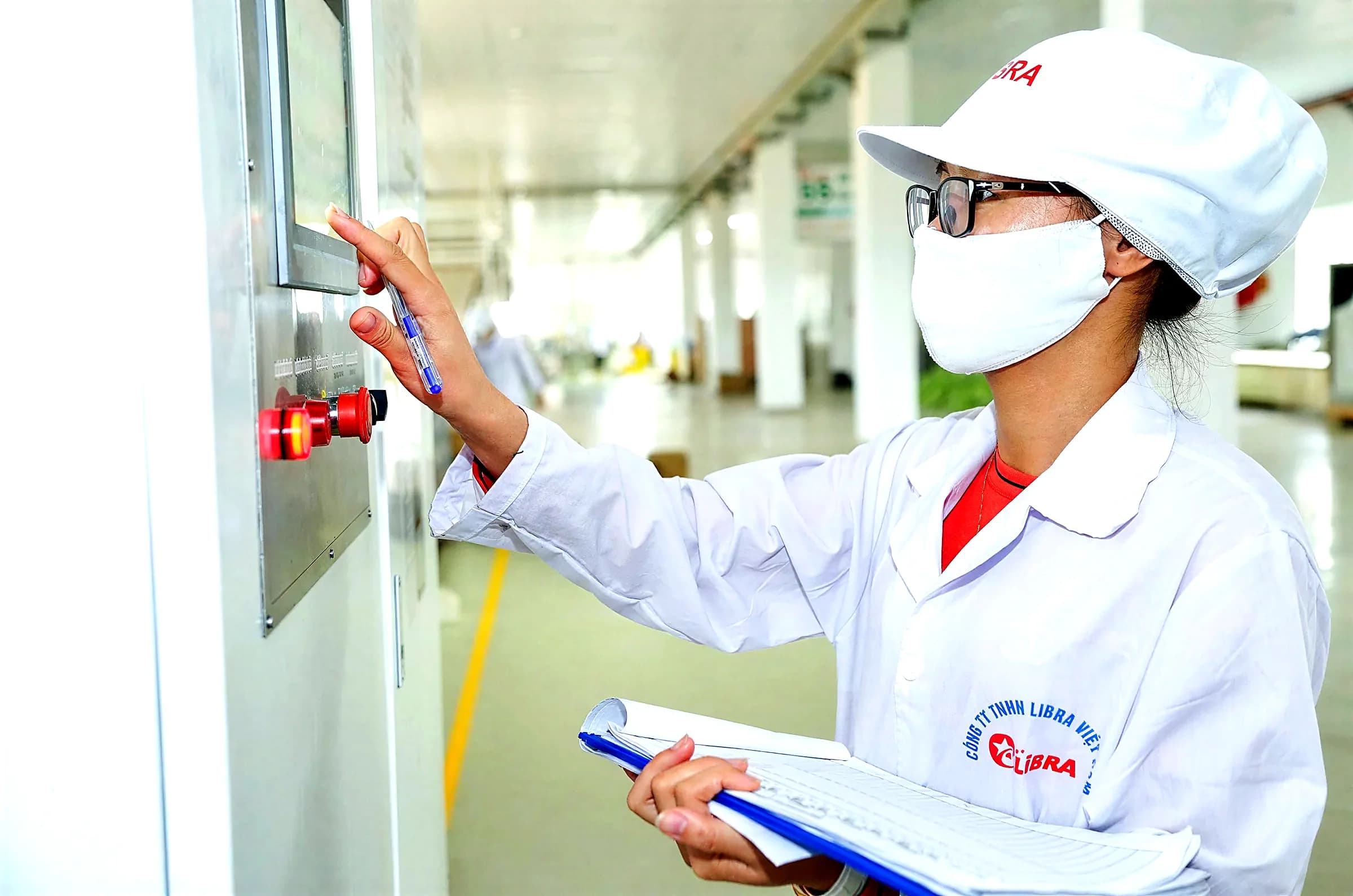 Quality control operator checking a line panel